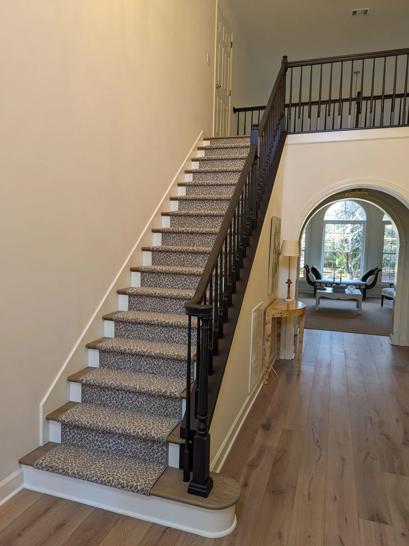 PXL_20231010_194450732 A staircase with wood floors and white walls.